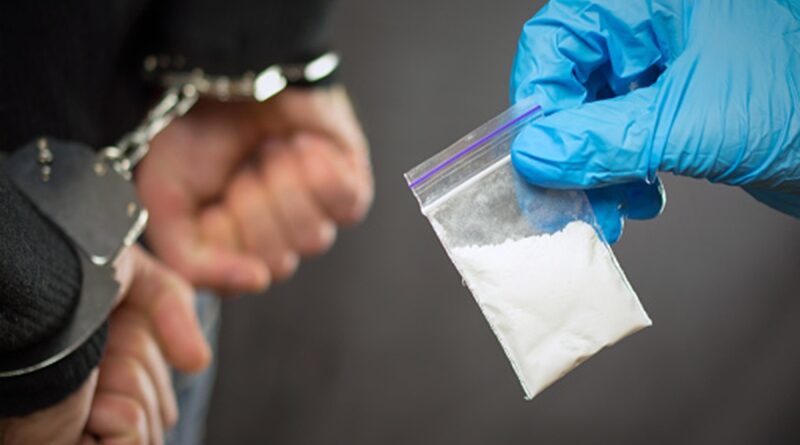 A police officer finds drugs during the search of drug dealers